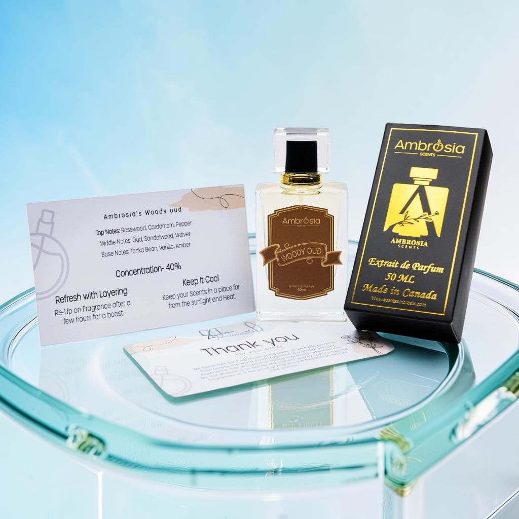 Ambrosia Scents Woody Oud Extrait De Parfum 50ml bottle with black and gold packaging, featuring rosewood, cardamom, pepper, oud, sandalwood, vetiver, tonka bean, and amber notes.